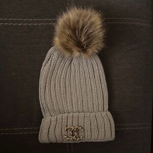 CHANEL Upcycled Brooch on a Gray Knit Hat with Faux Fur Pom